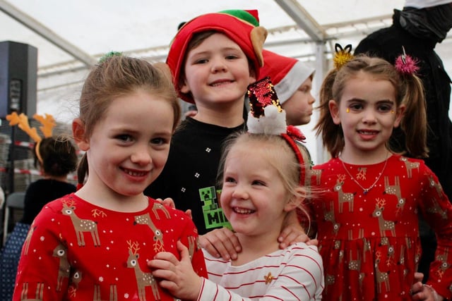 It's smiles all round from these youngsters in their Christmas outfits.