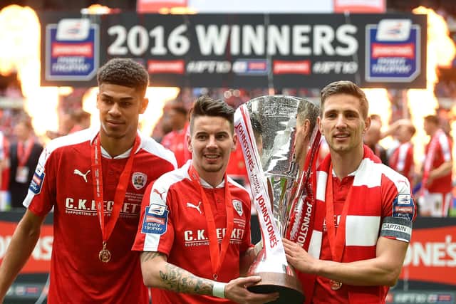 Ashley Fletcher, Adam Hammill and Conor Hourihane of Barnsley celebrate with the trophy during the Johnstone's Paint Trophy Final match between Oxford United and Barnsley at Wembley Stadium on April 3, 2016 in London, England. (Photo by Tom Dulat/Getty Images).
