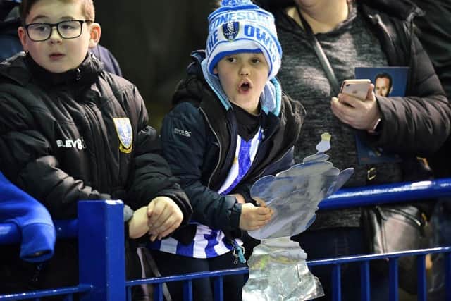 A young Owls fan holds a home-made trophy ahead of the English FA Cup fifth round football match between Sheffield Wednesday and Manchester City back in March 2020.