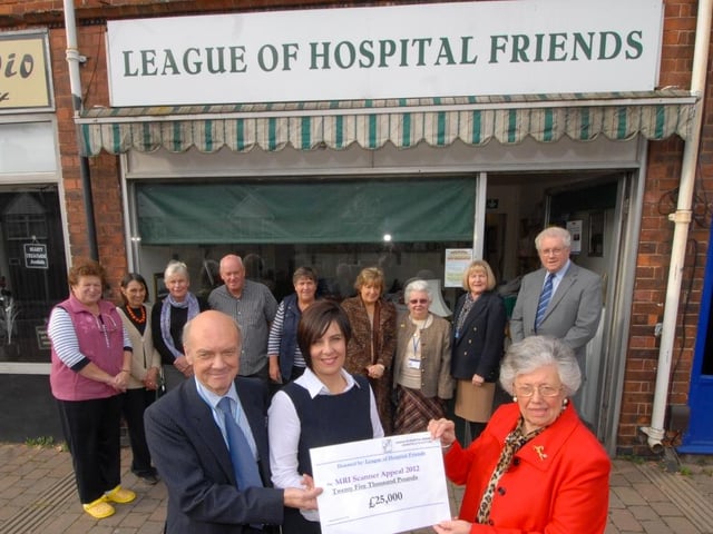 Barbara Joule, Chairman of Mansfield Hospitals League of Friends presents a cheque for #25,000 to former Chad editor Tracy Powell towards the trust’s scanner appeal in 2013.