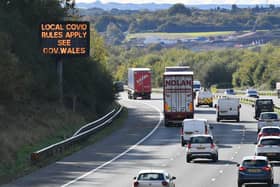 A matrix sign on the M4 motorway near Cardiff in Wales reminds motorists of coronavirus rules. PA