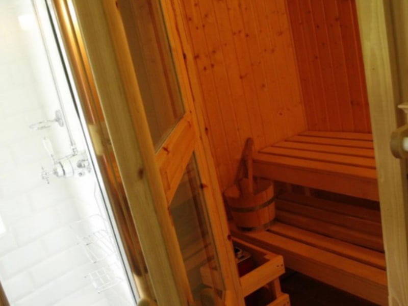 The sauna is located a few steps away from the kitchen.