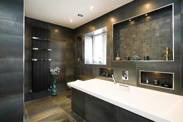 A stunning en-suite. The colours and finish are amazing, with a walk in shower just around the corner on the left of the image.