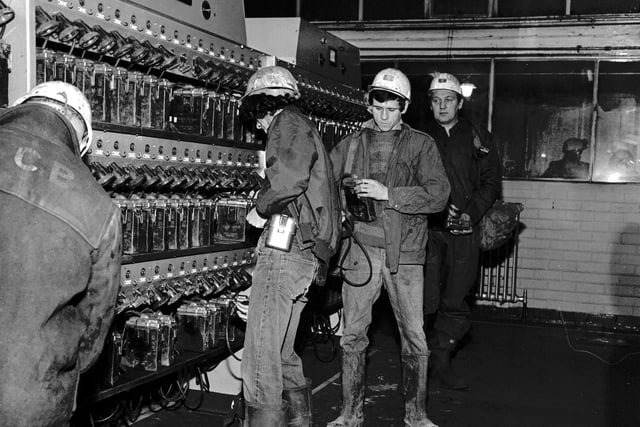 Miners at Monktonhall colliery collect their lamps from the lamphouse on one of the first shifts back after the strike ended in February 1972.