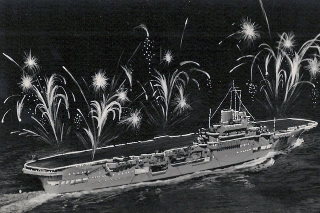 The fleet lit up for the Coronation Fleet Review at Spithead in 1953. HMS Indomitable.