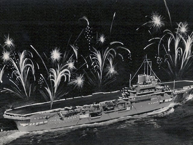 The fleet lit up for the Coronation Fleet Review at Spithead in 1953. HMS Indomitable.