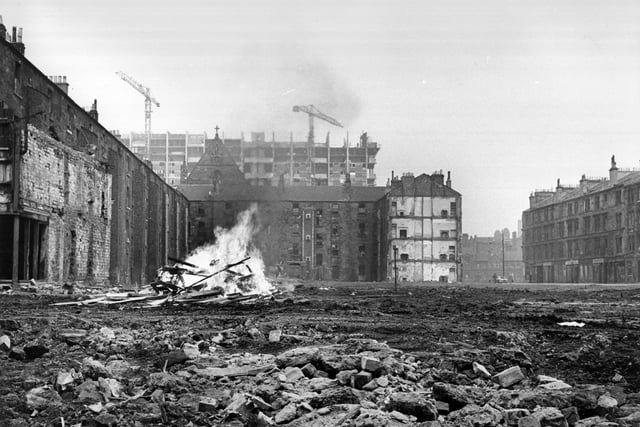 1960:  An area of cleared ground in the Gorbals where debris from the newly-demolished slum tenements is being burnt on a bonfire.