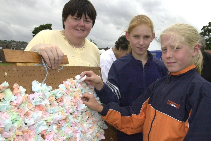 Janet Blackburn at the Loxley Silver Band stall looks on as Kristine Gregory and Laura Hall  tried their hand at the lucky dip back in 2001
