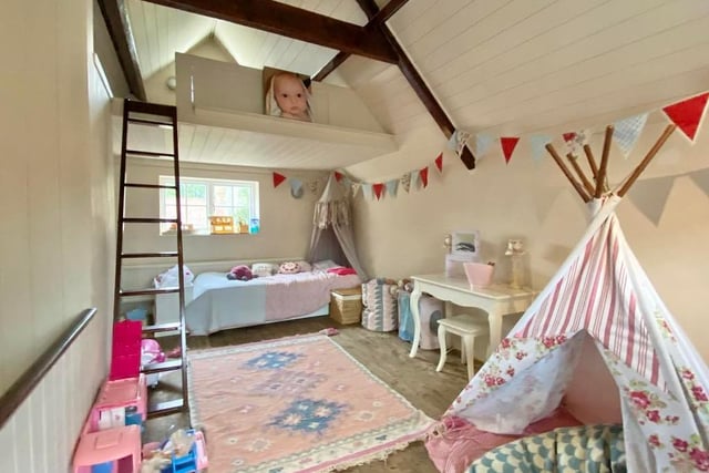 The annexe includes this bedroom, which has a useful mezzanine area too. There are windows at the front and back, as well as a storage cupboard.