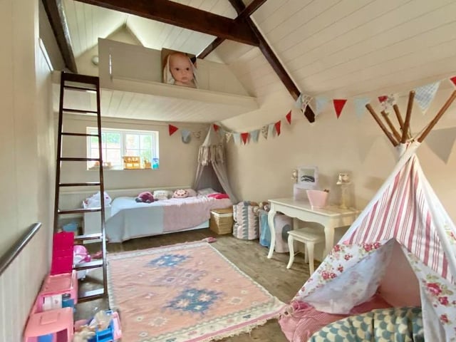 The annexe includes this bedroom, which has a useful mezzanine area too. There are windows at the front and back, as well as a storage cupboard.
