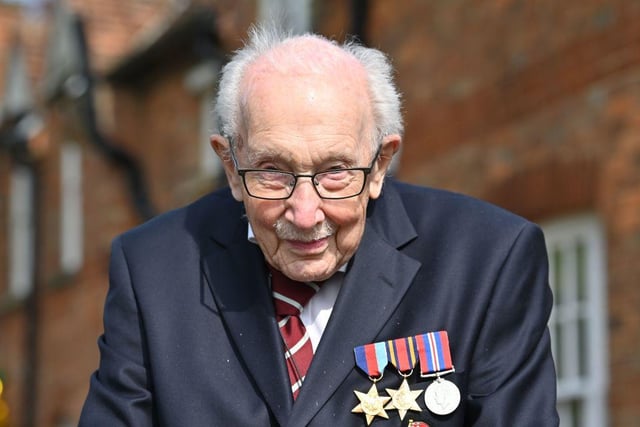British World War II veteran Captain Tom Moore, then aged 99, poses while doing a lap of his garden in the village of Marston Moretaine, 50 miles north of London, on April 16, 2020. (Photo by JUSTIN TALLIS / AFP)