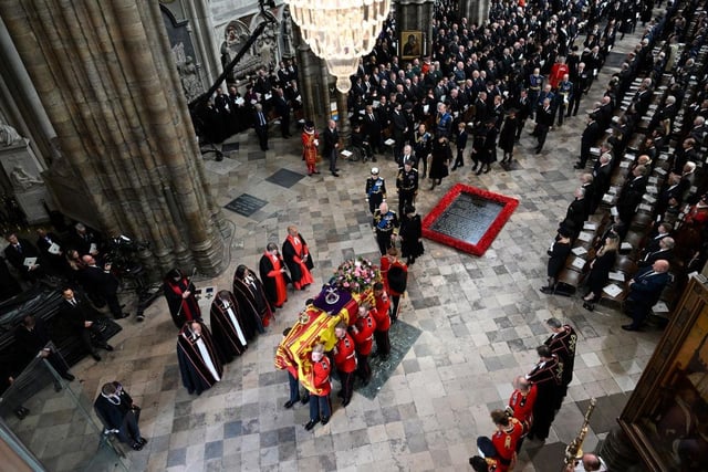 The coffin of Queen Elizabeth II with the Imperial State Crown resting on top of it departs Westminster Abbey. Photo by Gareth Cattermole/Getty Images