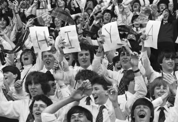 Youngster hold up a HIYA sign for Pope John Paul II at Murrayfield during the Papal visit to Scotland in May 1982. 40.000 young people from all over Scotland came for the Scottish National Youth Pilgrimage, singing 'You'll Never Walk Alone" and chanting John Paul, John Paul. 