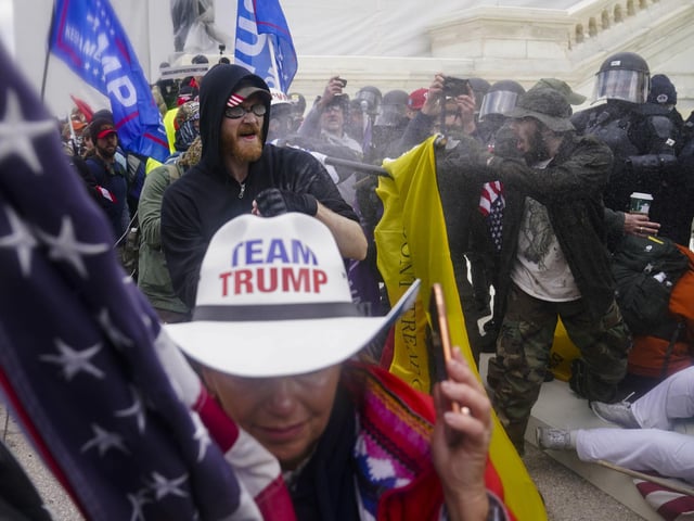 Trump supporters try to break through a police barrier