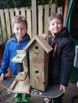 Alex and Oliver with the birdhouse they made with their dad