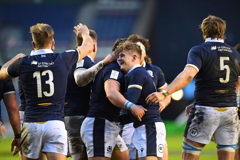 Scotland's wing Darcy Graham (CR) celebrates with team-mates after scoring a try during the Six Nations international rugby union match between Scotland and Wales at Murrayfield