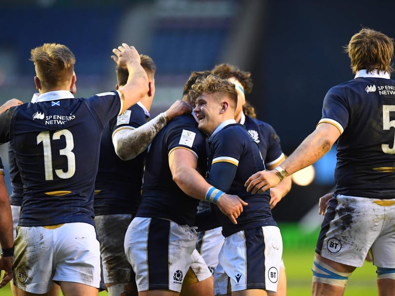 Scotland's wing Darcy Graham (CR) celebrates with team-mates after scoring a try during the Six Nations international rugby union match between Scotland and Wales at Murrayfield