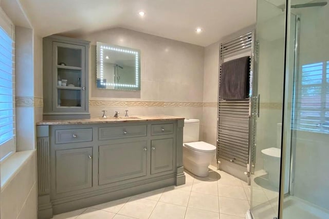 The en suite facilities to the master bedroom are bathed in luxury. The room is fitted with a contemporary suite, comprising shower enclosure, low-flush WC, vanity unit with marble top and inset wash basin, plus a vertical, heated towel-rail.