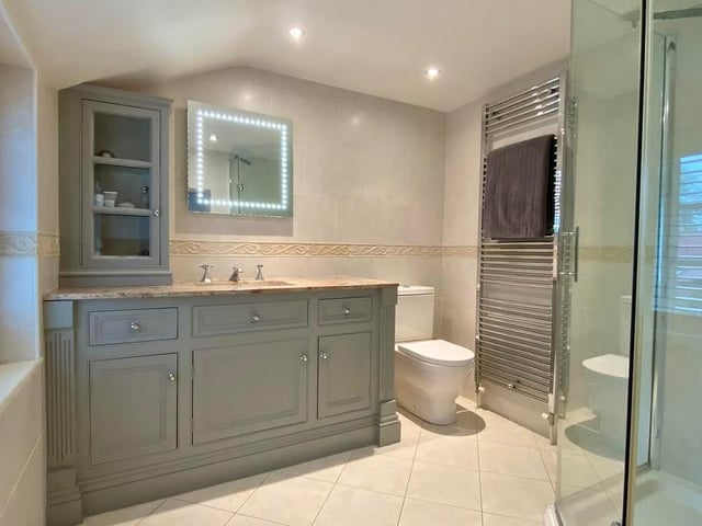 The en suite facilities to the master bedroom are bathed in luxury. The room is fitted with a contemporary suite, comprising shower enclosure, low-flush WC, vanity unit with marble top and inset wash basin, plus a vertical, heated towel-rail.