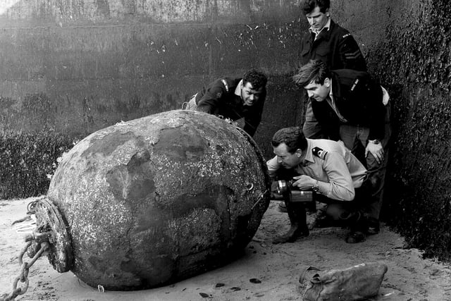 A Royal Navy bomb and mine disposal unit looking at a mine from World War II found at Queensferry in June 1965.