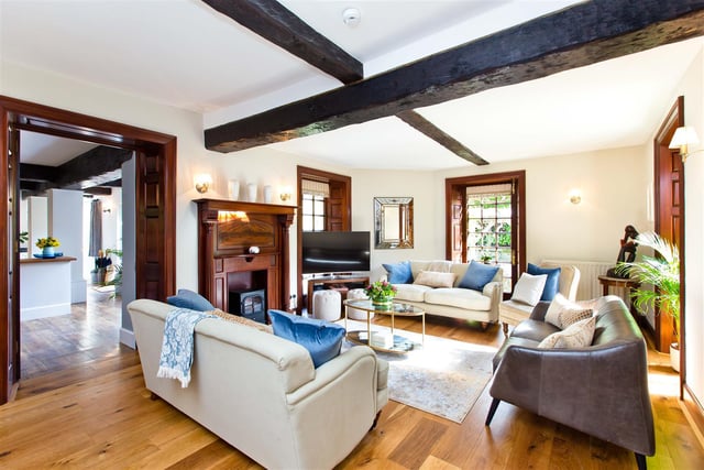 The sitting room is decorated in neutral décor with a mahogany finish and solid oak floor. Its floor to ceiling windows attract masses of light.