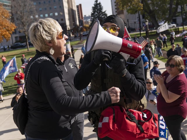 A Trump supporter demonstrating the election results shouts with a counter protestor at the State Capitol in Lansing, Mich (AP Photo/David Goldman)