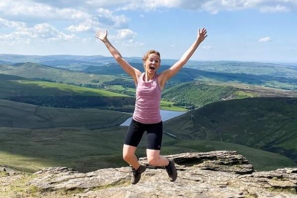 fiona.glow.getter posts this photo, saying: "Here’s an action shot of me today at the highest point in the Peak District after hiking up with some friends from work"