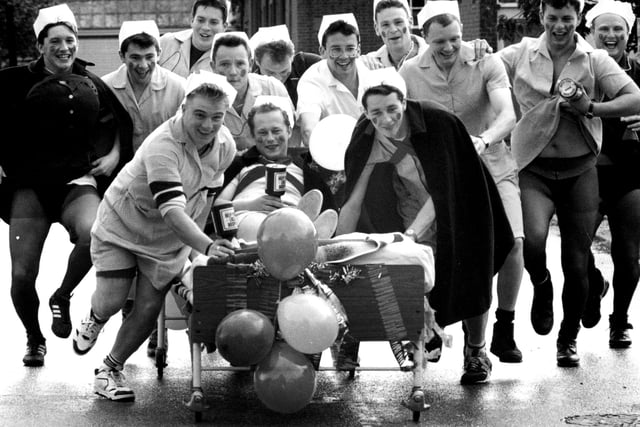 Weapons Engineering Mechanics from HMS Collingwood take charge with a charity bed push from Wykeham day Hospital to Fareham, 1993. The News PP5532