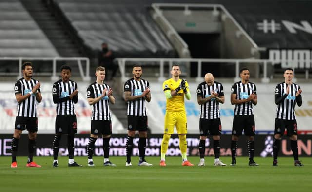 Players of Newcastle United participate in a minute of applause in memory of former Newcastle United player Glenn Roeder during the Premier League match between Newcastle United and Aston Villa at St. James Park on March 12, 2021 in Newcastle upon Tyne, England.