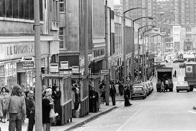 Shoppers queue for buses outside Woolworth's on The Moor in 1976