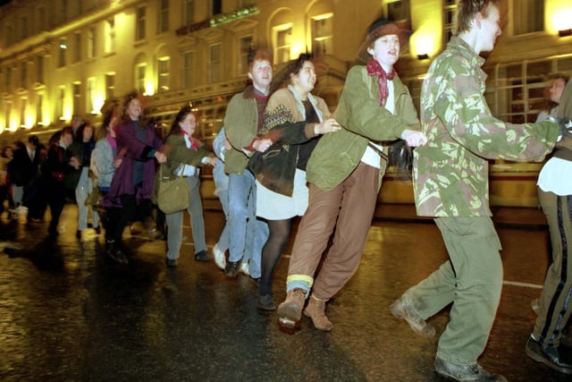 Glaswegians celebrate the end of Glasgow Year of Culture with a street party and conga line in George Square on Hogmanay 1990.