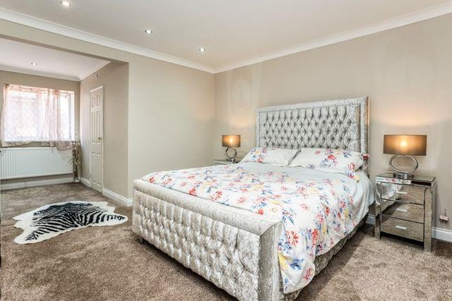 This bedroom is spacious and bright, and also features spot lights