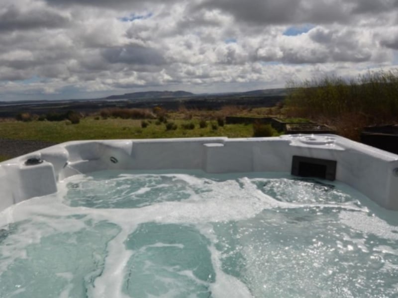 The hot tub has amazing views over the surrounding countryside.