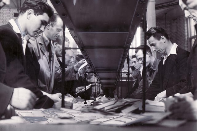 Postal workers sorting the letters into bundles, with the stamps at the top ready for franking, in September 1949