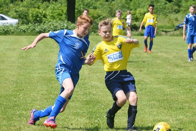 Dunscroft's Jack Rayner and Brodsworth's Spencer Jackson in action.