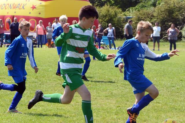Rossington's Robin Shepherd (right) shields the ball.
