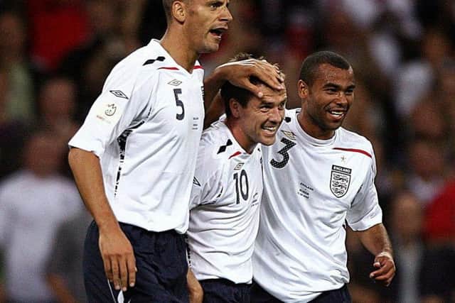 England's Michael Owen (centre) celebrates scoring the second goal of the game with team mates Rio Ferdinand (left) and Ashley Cole during the UEFA European Championship Qualifying match at Wembley Stadium. Picture date: Wednesday September 12, 2007.