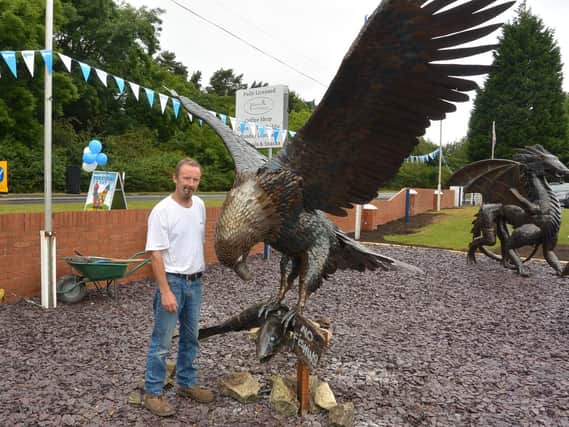 Ian Curran with his eagle sculpture.
