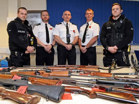 Superintendent James Abdy, Operations Sheffield West, District Commander David Hartley and Superintendent Shaun Morley, with armed response officers and firearms recovered recently from across Sheffield