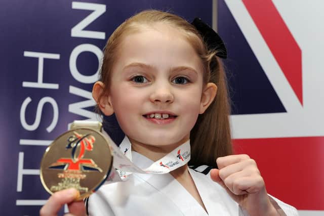 Caitlin with her gold medal she won for the -23kg girls category at the British National Taekwon-Do Championships