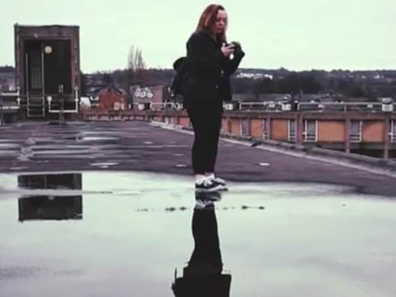 A girl on the roof of Sheffield's Park Hill flats. (Photo: YouTube).