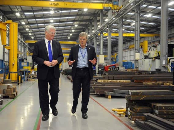 Defence secretary Sir Michael Fallon with Tinsley Bridge Group managing director Mark Webber during a tour of the firm's facilities in Sheffield