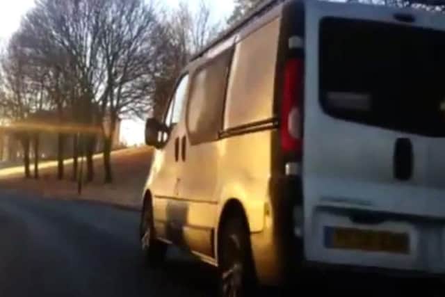 A van races past a biker in the city. (Photo: YouTube).