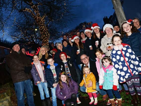 Carol singing under the Christmas lights in Abbeydale Park Rise.