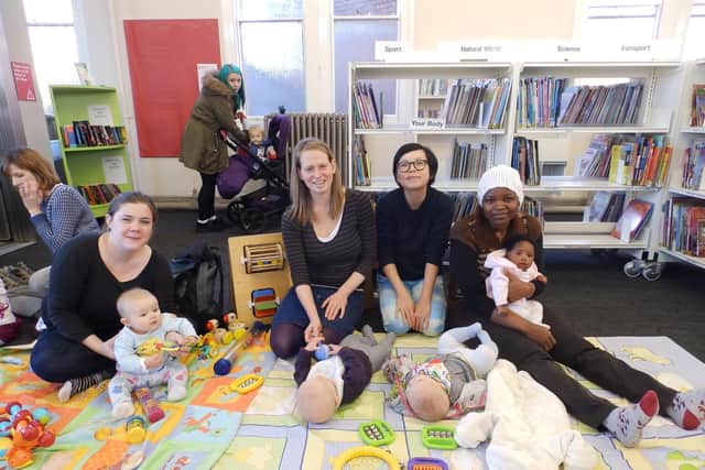 Parents and their children at the library's baby time session