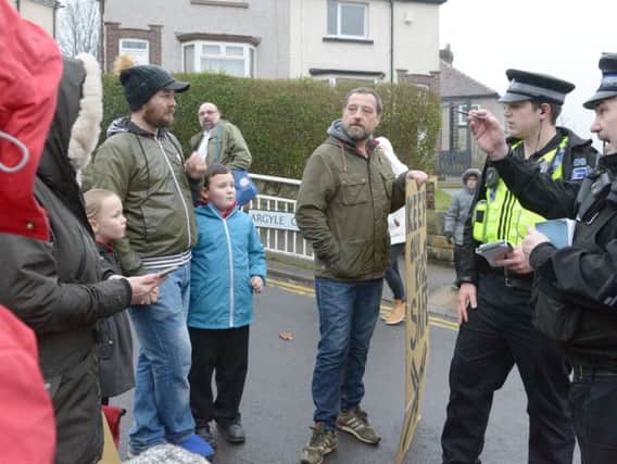 Police speak to protesters outside Carfield Primary School