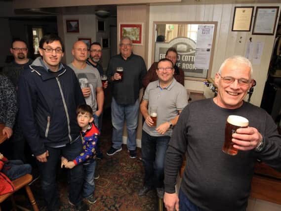 Pub landlord Gary Bell with regulars at the Firwood Cottage