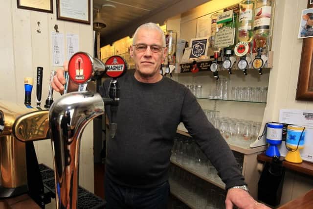 Gary Bell behind the bar at the Firwood Cottage pub