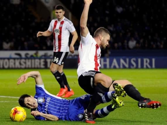No penalty - Fernando Forestieri tangles with Harlee Dean in the box....Pic Steve Ellis