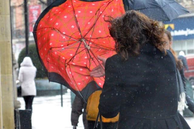 The storm caused havoc with this lady's umbrella in Sheffield.